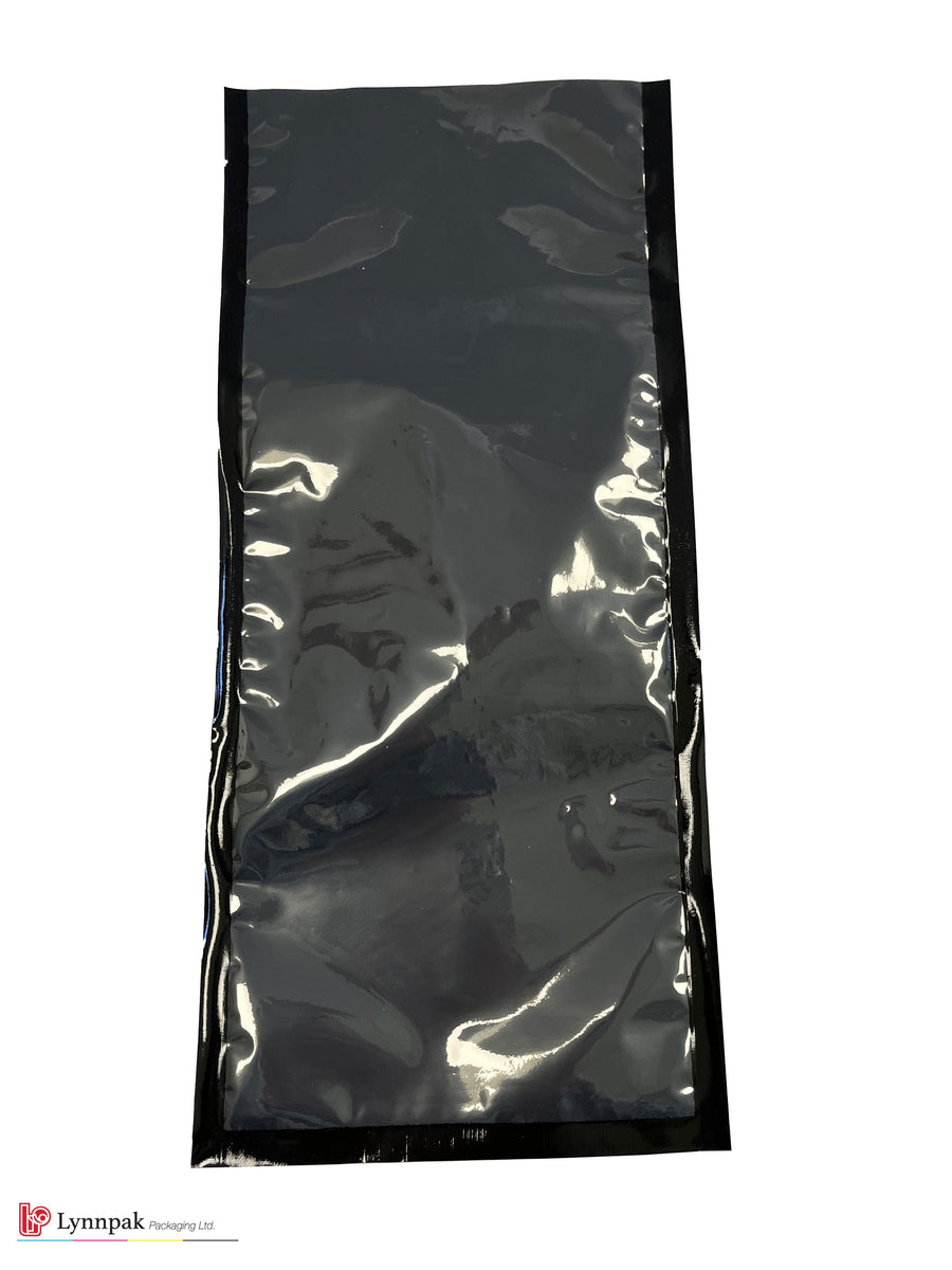 Vacuum food bag, one side clear, one side black, sized 5.75"x13", with meat