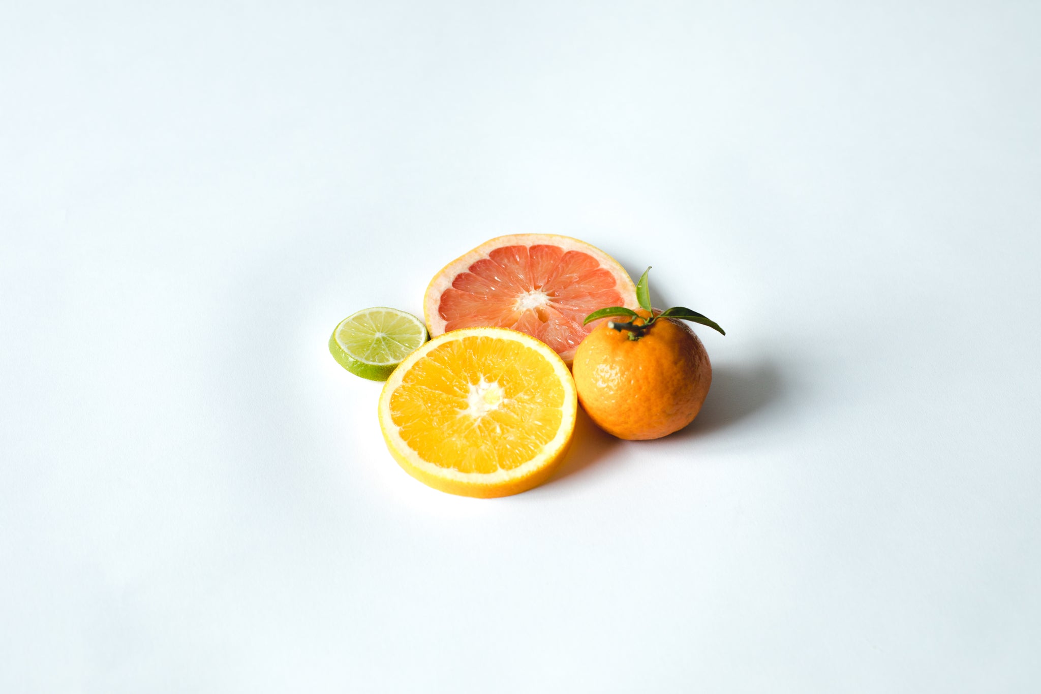 Fresh fruit collection of sliced lemon, lime, grapefruit and a tangerine.